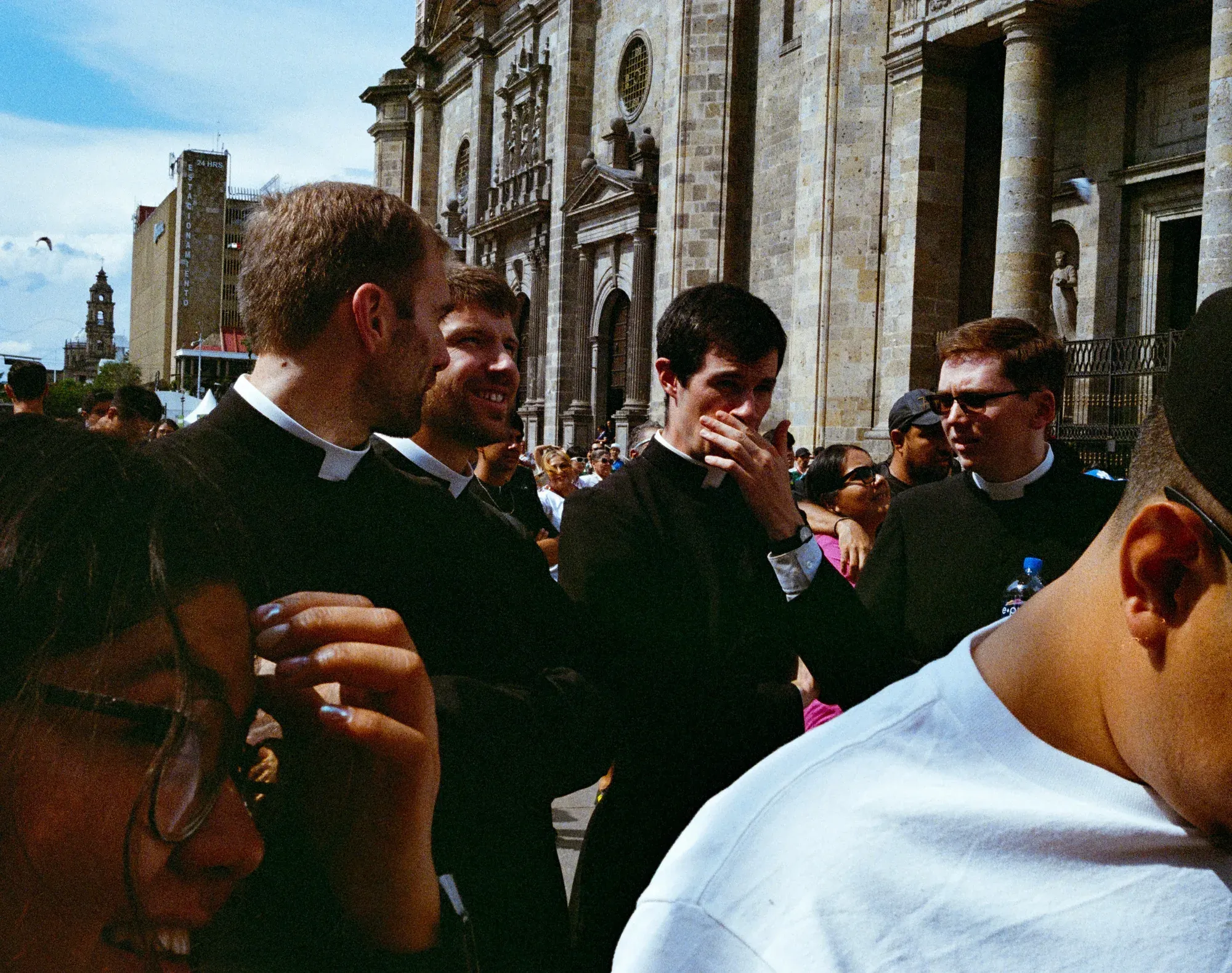 Grupo de sacerdotes jóvenes conversa frente a la catedral de Guadalajara